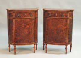 A pair of George III demi-lune cabinets, estimate £8,000-12,000, to be auctioned on Friday 11th October 2013.