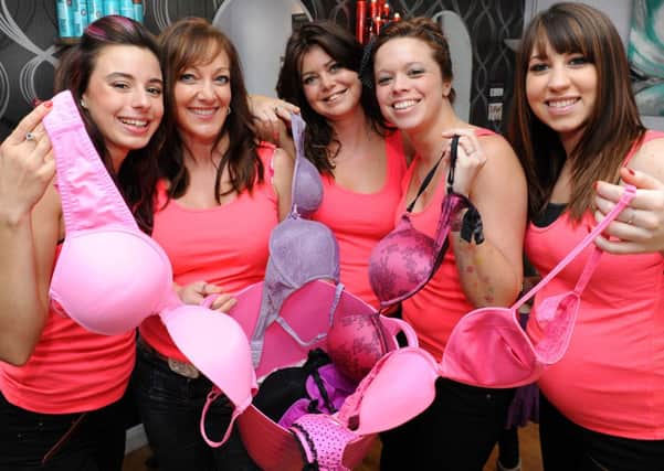 JPCT 081013 Staff at Stands hairdressing salon in Horsham supporting the Bin your Bra campaign. L to R Nicole Meer, Tracey Bowyer, Helen Miles, Jenni Miles and Brooke Hartley. Photo by Derek Martin
