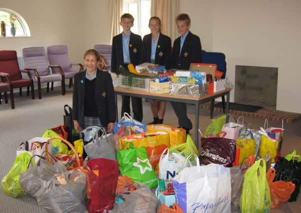 Cranleigh prep school pupils, Bea, George Sam and Julie at Rowleys with Harvest Gifts