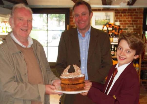 Pictured, from the lert, Mike Imms, Nick Herbert MP and Joe Hughes-Cornick with the birthday cake Joe made