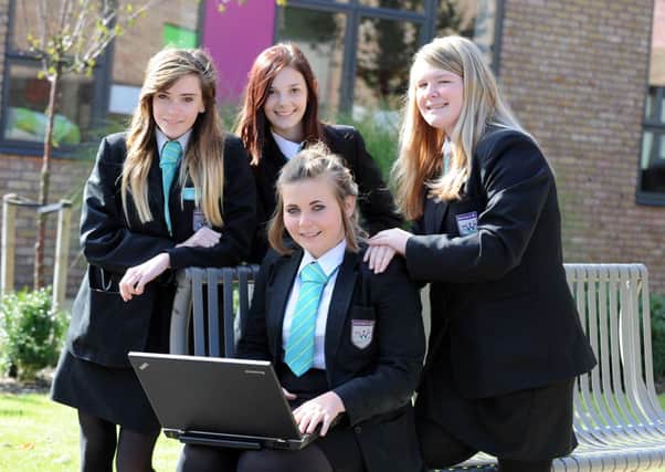 W42331H13 Gemma Flowers gets support from friends, back left to right, Sahar-re-Betteridge, 14, Geogina Samuel, 14 and Jade Howick, 14, at Sir Robert Woodard Academy in Lancing for her latest fundraising campaign