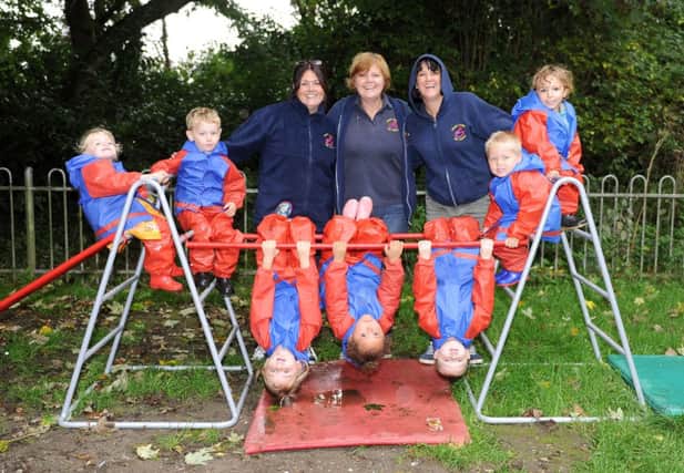 W41011H13 Children with the new frame and in their new waterproof clothing with teachers, Sarah Weedon, manager Kim Fessey and Lynsey Dixon.