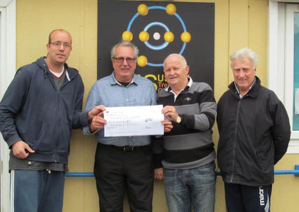 Sean Sallis, Tony Dineen and Mick Fogden present the cheque to Sussex MS Treatment Centre manager Alan Taylor, second left
