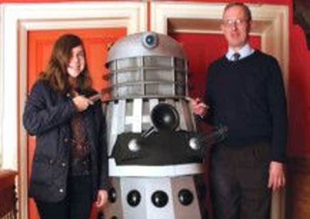 Whovian Emma Toovey with Jeremy Knight, Head of Museums & Heritage, and a Dalek.