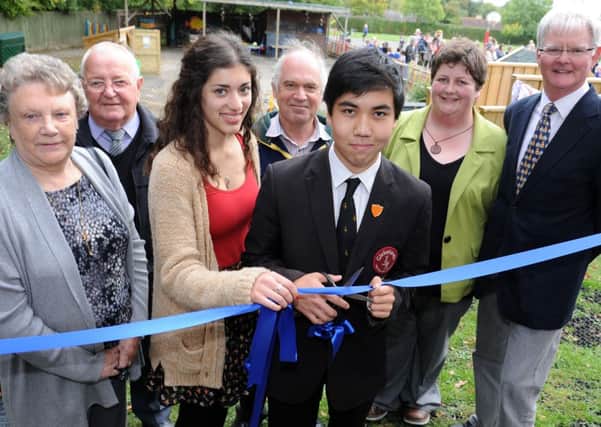 JPCT 181013 S13411715x Rudgwick Primary School.  Opening of Early Years Outdoor Space. Priya Sodha, head girl Weald, Itsuki Kurshina, head boy Glebelands, cut ribbon with school staff and supporters -photo by Steve Cobb