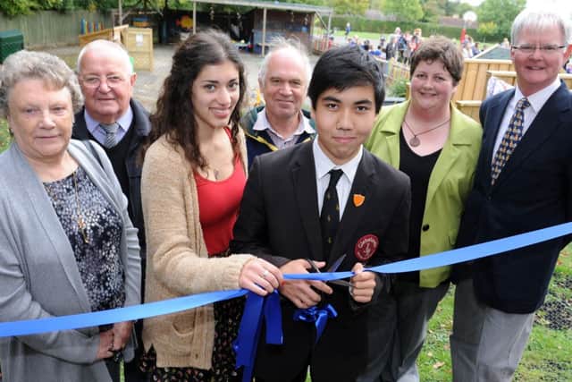 JPCT 181013 S13411715x Rudgwick Primary School.  Opening of Early Years Outdoor Space. Priya Sodha, head girl Weald, Itsuki Kurshina, head boy Glebelands, cut ribbon with school staff and supporters -photo by Steve Cobb