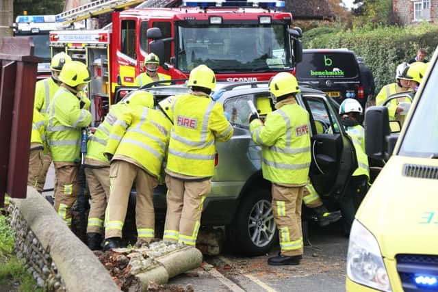 The fire service help to free the driver of the crashed car