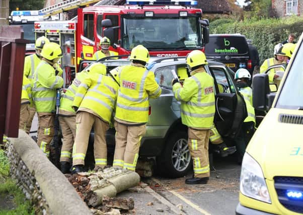 The fire service help to free the driver of the crashed car