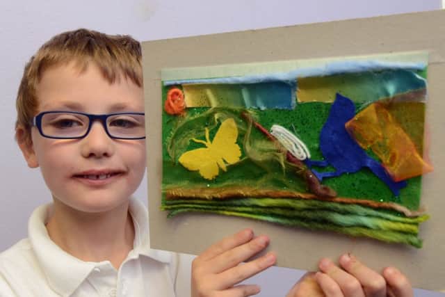 S43730H13 Will Ansell with his work at the landfill art workshop at Glebe Primary School in Southwick