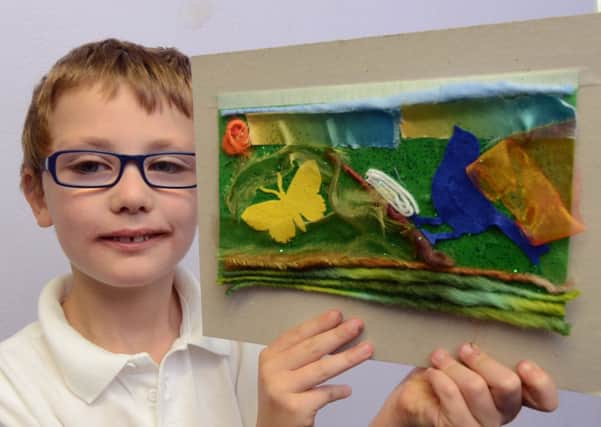 S43730H13 Will Ansell with his work at the landfill art workshop at Glebe Primary School in Southwick