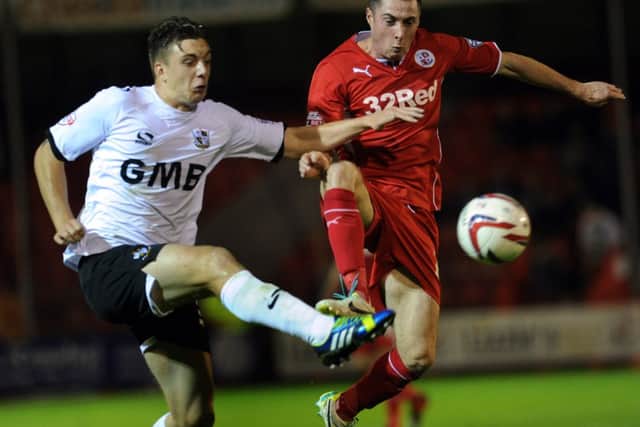 Crawley Town's Mike Jones battles for possession witha  Port Vale opponent