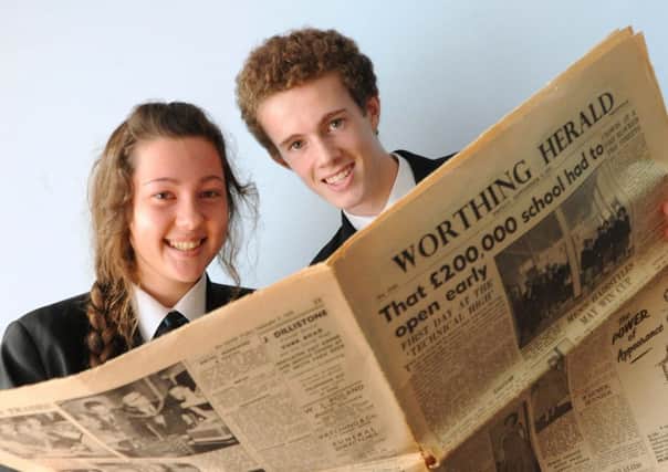 Durrington High School head boy Tom Walker and head girl Zoe Chellingworth with a Worthing Herald with a report of the school opening  W43581H13