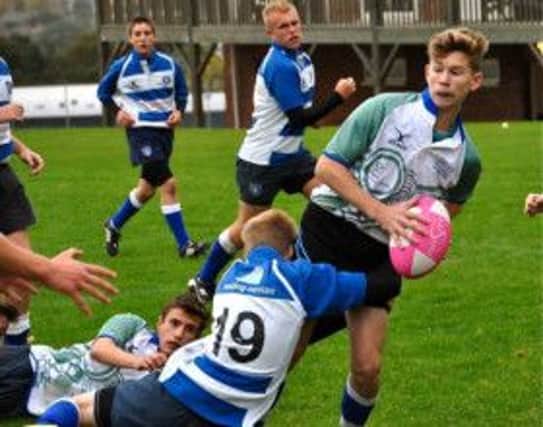 Jack Dixon offloads for Hastings & Bexhill Rugby Club's under-16 team