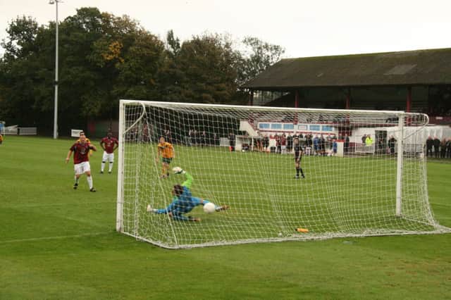 Sam Adams scores from the penalty spot during Hastings United's 4-2 win over Horsham last weekend. Picture by Terry S. Blackman