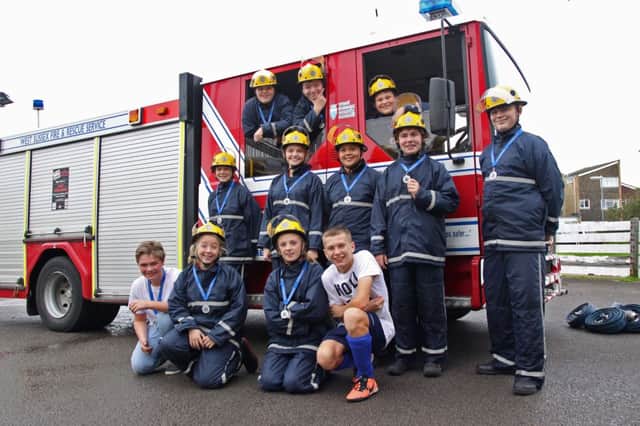 The students at Lancing Fire Station with their medals