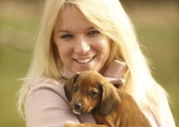 Hanah Macey from Dogs Trust with a puppy