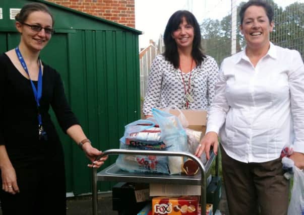 Teachers from Swiss Gardens Primary School in Shoreham help load up the food collected