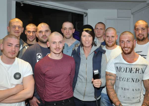 The men show off their head shaves with Jackie Keane  on Friday evening  pic Phil Dennett