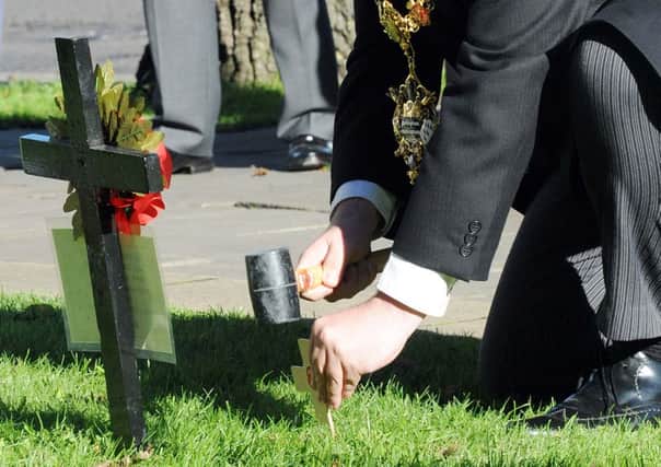 W45707H13 Bob Smytherman plants the first cross at the opening of Worthing's Garden of Remembrance