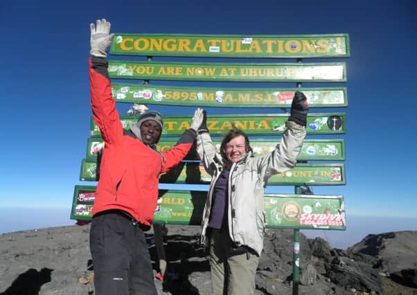 Jennie Tindall reaches the summit of Mount Kilimanjaro