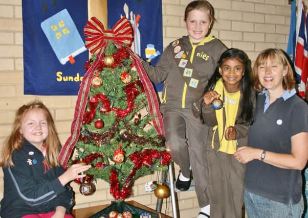 Children decorate a Christmas tree Horley Methodist Church