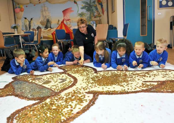 Pupils at River Beach Primary School, in Littlehampton, with their Pudsey coin collector    L47205H13