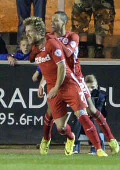 Crawley Town's Billy Clarke is congratulated by his team-mates for scoring his side's equaliser at Carlisle Utd
