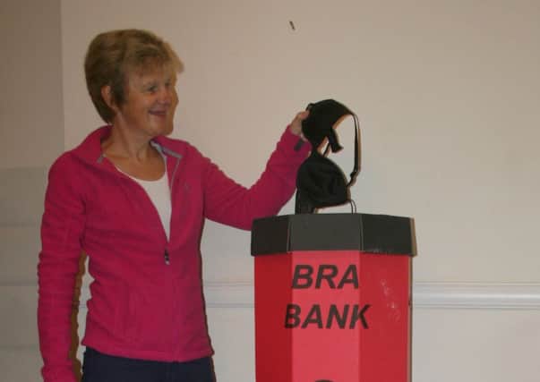 Sue Burton with Bra collecting bin and overflowing sack, filled and ready to go to Africa