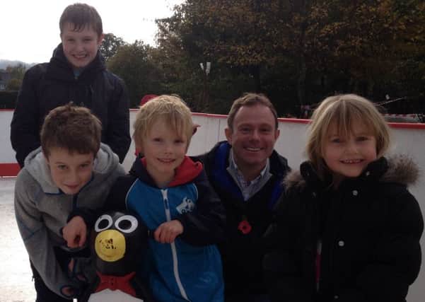 Nick Herbert MP on the ice rink with (L to R) Lewis and Finlay Pitt, Indiana Flack and Esther Pitt.