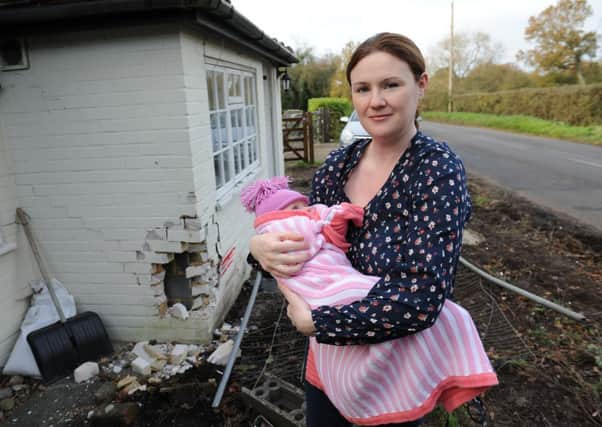 JPCT 161113 Katie Gilmour's house was crashed into by a car for second time in less than two months. Pictured holding 13 week old Sophie.