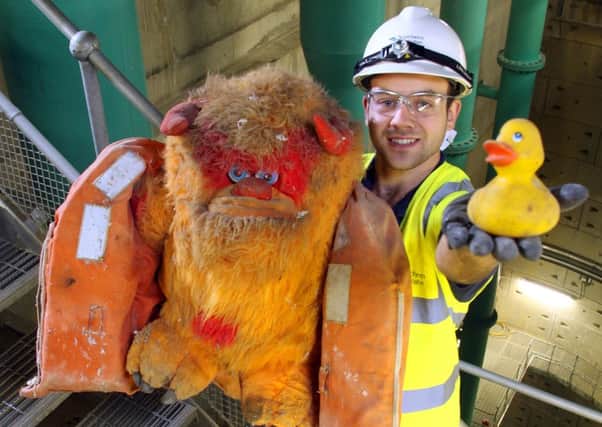 Southern Waters Martin Coote with Bruce, a lifejacket and a rubber duck, all found in the sewerage system