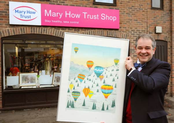 JPCT 181113 Mary How Trust Patron Rupert Toovey holding one of a number of donated pictures. Photo by Derek Martin