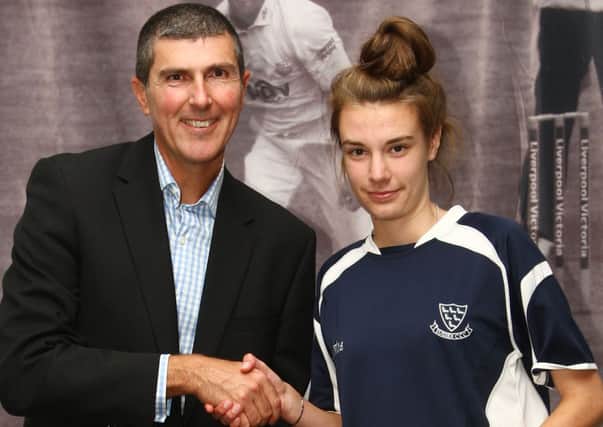 Beth Harvey receives her award from Sussex professional cricket manager Mark Robinson