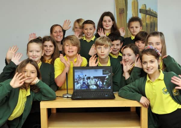 Pupils talk to the Duchess of Cornwall on Skype from their twin school in Kochi, India. Pictured are Year-six pupils with form teacher, Kerry Dolan   L47352H13