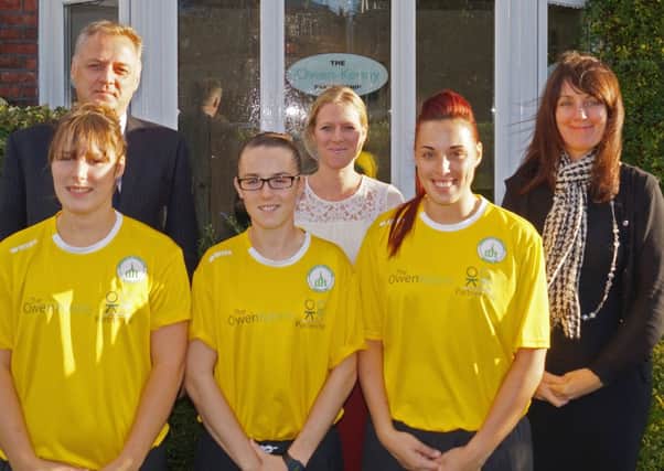Chichester Ladies' players show off their Owen Kenny-sponsored shirts with staff from the legal firm  Picture by Darran Stevens