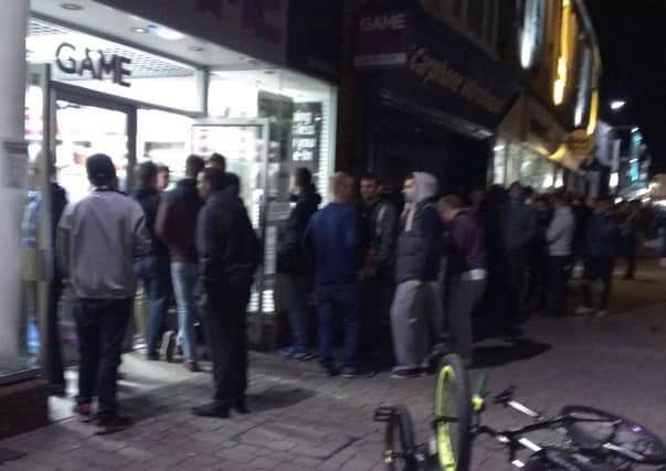 Gamers queue outside Horsham's Game store at midnight in September