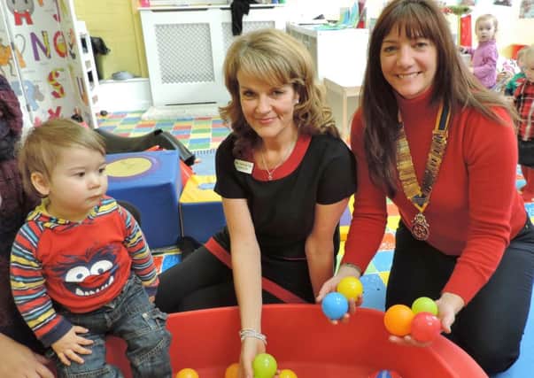 Carolyn Henton (left) of The Learning Tree nursery school, in Arundel, with Helen Seller, president of Arundel Rotary Club, which has made a donation to but more toys at the nursery, and nursery pupil Harvey Rose
