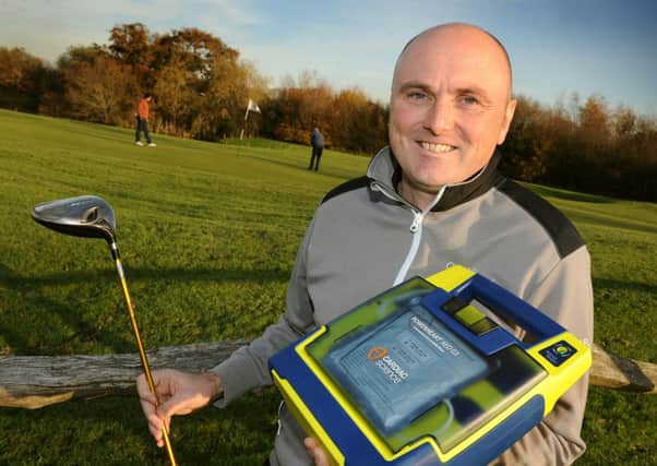 The joint manager of the Mid Sussex Golf Club, Lee Andrews with the defibrillator that helped saved the life of a golfer next to the 9th green