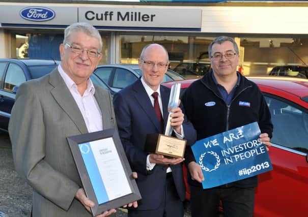 Cuff Miller presentation. Investors in People Award and Ford Outstanding Customer Service Award. Pictured L-R Mike Turner (Team Principal), MP Nick Gibb and Mark Lambert (Assistant Sales Manager). Cuff Miller Garage, Littlehampton.