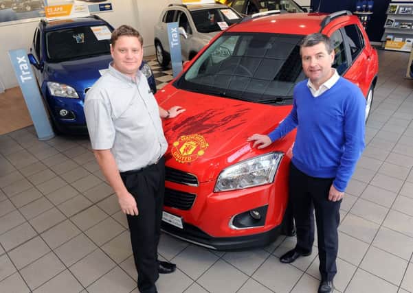 S48883H13 Manchester United legend Denis Irwin, right, and Toby Frost with the car at the Shoreham showroom