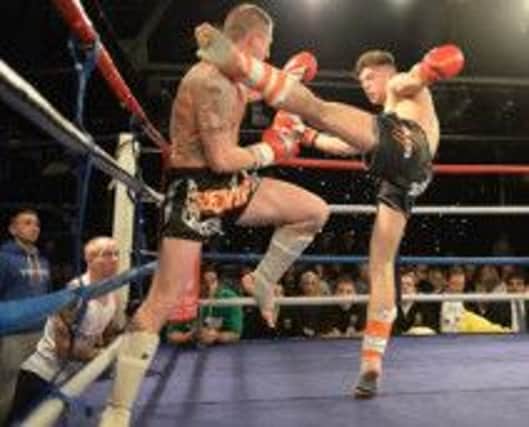 Jamie McGuigan, of the Fighting Tigers Gym, lands a kick during his splendid victory in Rochester