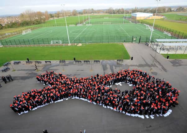 More than 500 hundred children at The Littlehampton Academy with their finished human ribbon for World AIDS Day L48774H13