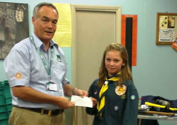 Chloe Coleman presents the Â£590 cheque to ShelterBox volunteer Mike Barker