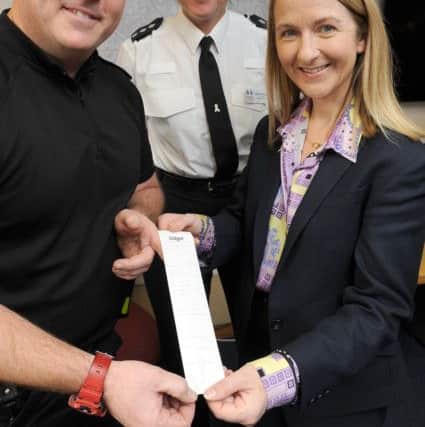 JPCT 291113 Launch of police drug-drive  testing equipment. L to R Sgt Stewart Goodwin, Chief Inspector Natalie Moloney and Sussex Police and Crime Commissioner Katy Bourne and the test print-out. Photo  by Derek Martin