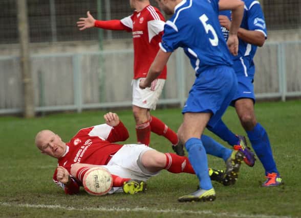A goalmouth scramble during Rye United's 2-2 draw away to Arundel. Picture by Liz Pearce