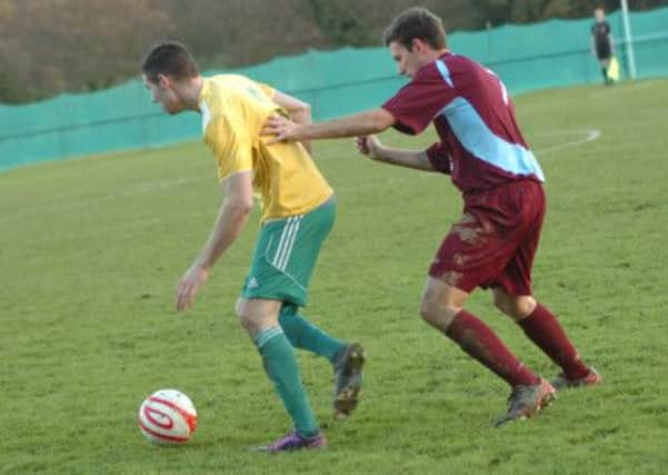 Westfield full-back Ross Markham shields the ball from Little Common wide player Jared Lusted. Picture by Simon Newstead