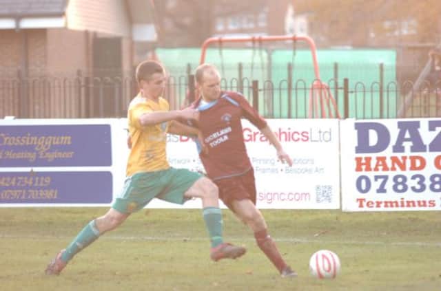 Little Common player-manager Russell Eldridge is closed down by Westfield striker Aaron Parris