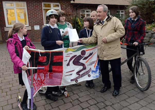 S49759H13

Skateboard Park Petition at the Steyning Centre on Monday. Phil Bowell receives the petiton