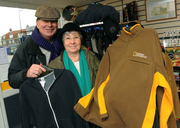 Tony Holley and Eileen Boots with some of the winter clothes at the Lions shop  W49513H13