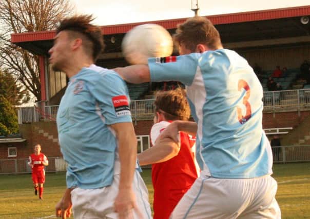 Tom Gilbert and Bruno Pacheco contest an aerial ball during Hastings United's league win away to Worthing on Saturday. Picture by Terry S. Blackman